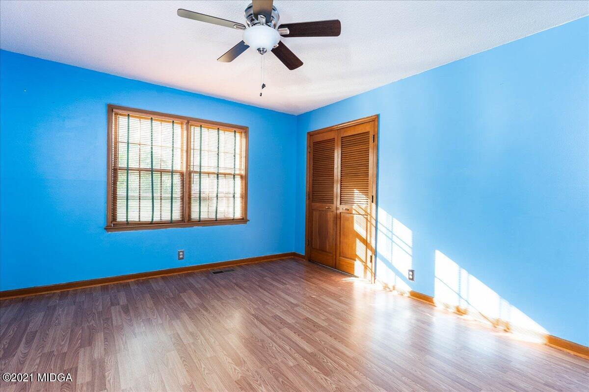 455 Lite-N-Tie Road Gray, GA 31032 - Photo 24 of 47 a view of empty room with wooden floor and fan