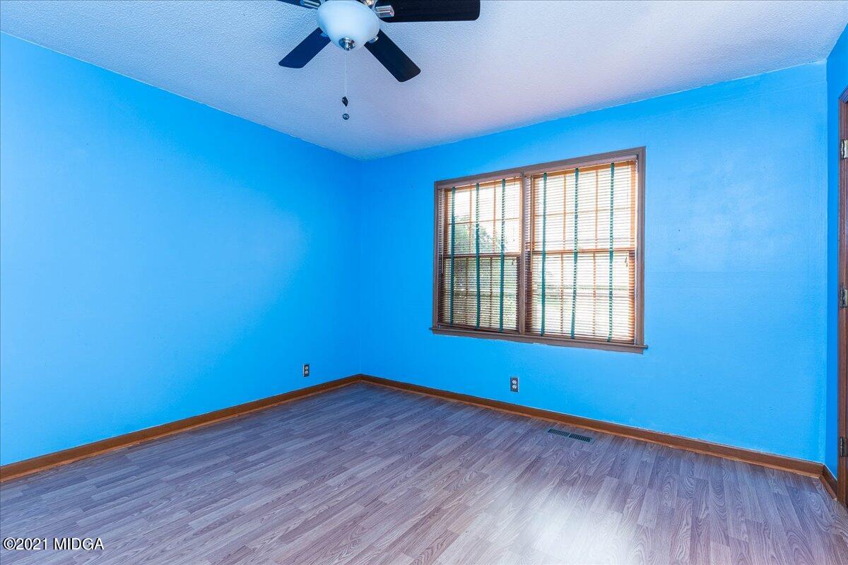 455 Lite-N-Tie Road Gray, GA 31032 - Photo 25 of 47 a view of empty room with wooden floor and fan