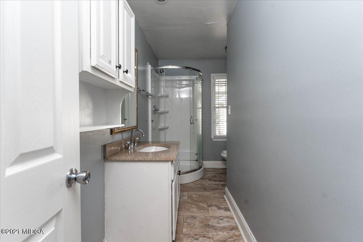455 Lite-N-Tie Road Gray, GA 31032 - Photo 26 of 47 a bathroom with a granite countertop sink a toilet and a mirror