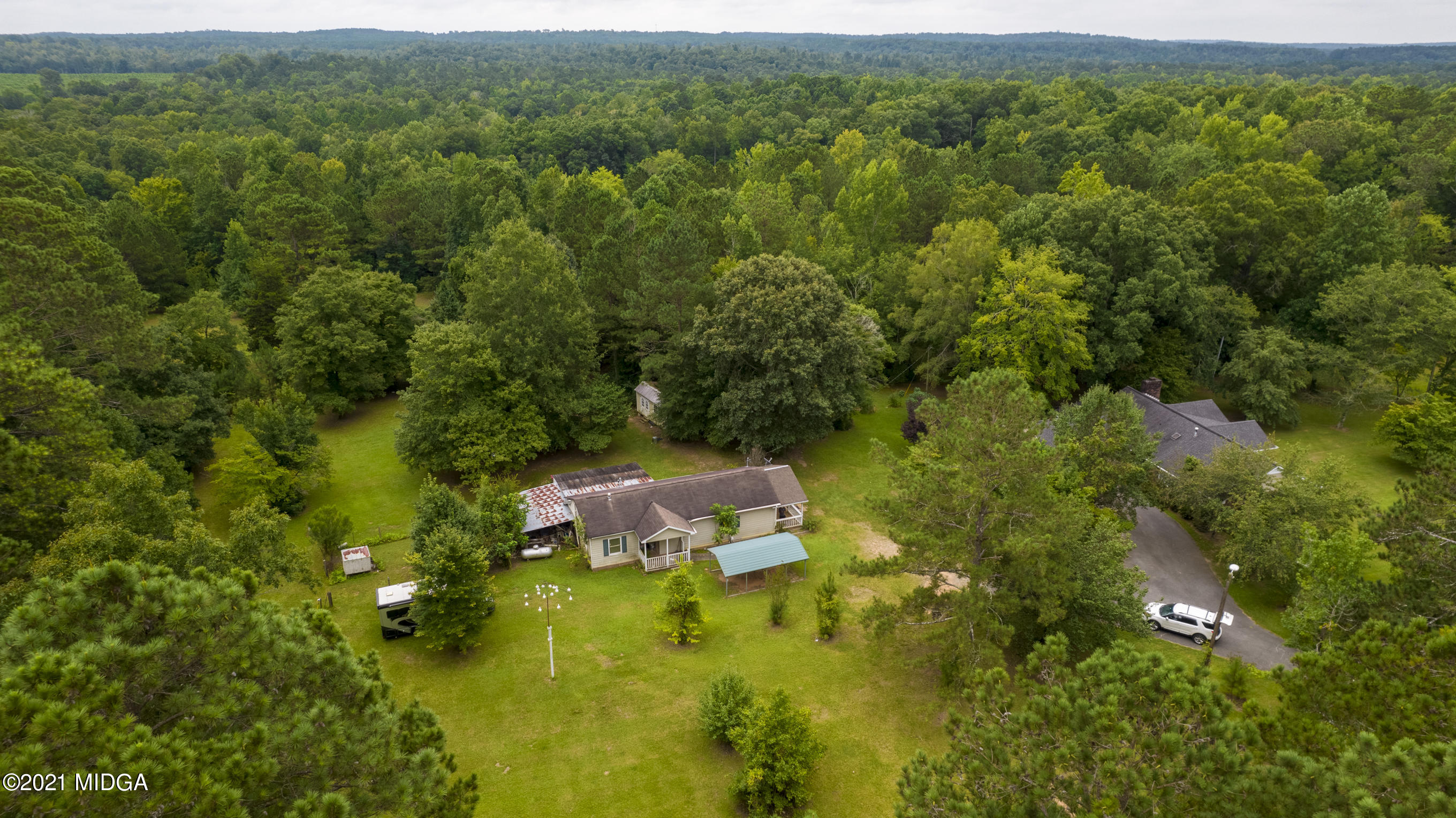 455 Lite-N-Tie Road Gray, GA 31032 - Photo 42 of 47 a view of a lush green forest with trees in the background