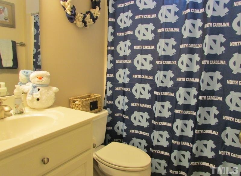 216 Piney Forest Road Roxboro, NC 27574 - Photo 13 of 23 Bathroom between the two bedrooms. Apparently the sellers are CAROLINA fans. We sill approve DUKE fans for showings.