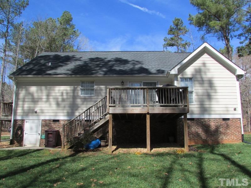 216 Piney Forest Road Roxboro, NC 27574 - Photo 15 of 23 The rear view of this home shows that you have storage space underneath, side walk that comes from concrete drive way to the deck steps