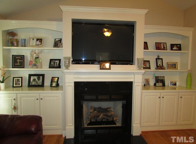 216 Piney Forest Road Roxboro, NC 27574 - Photo 5 of 23 The fireplace in the family room is a great focal point with the custom cabinets and shelving on each side.