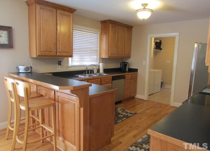 216 Piney Forest Road Roxboro, NC 27574 - Photo 7 of 23 Plenty of counter space and cabinets, eat at bar, stainless appliances too.