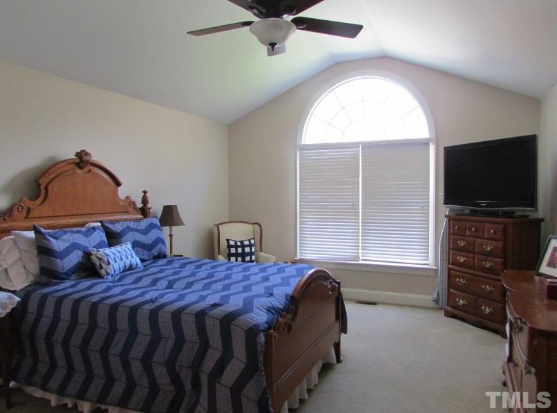 216 Piney Forest Road Roxboro, NC 27574 - Photo 9 of 23 Spacious master bedroom has a palladium window, vaulted ceiling and walk in closet.