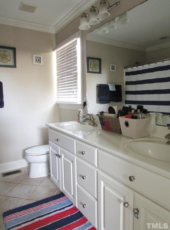 216 Piney Forest Road Roxboro, NC 27574 - Photo 10 of 23 Master bath with double sink vanity, tub shower combo, linen closet