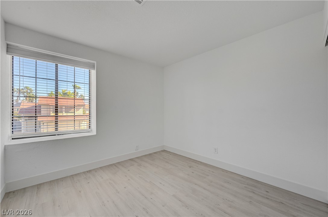6505 Deadwood Road Las Vegas, NV 89108 - Photo 22 of 33 Well-lit room featuring durable wood flooring and ample natural illumination.