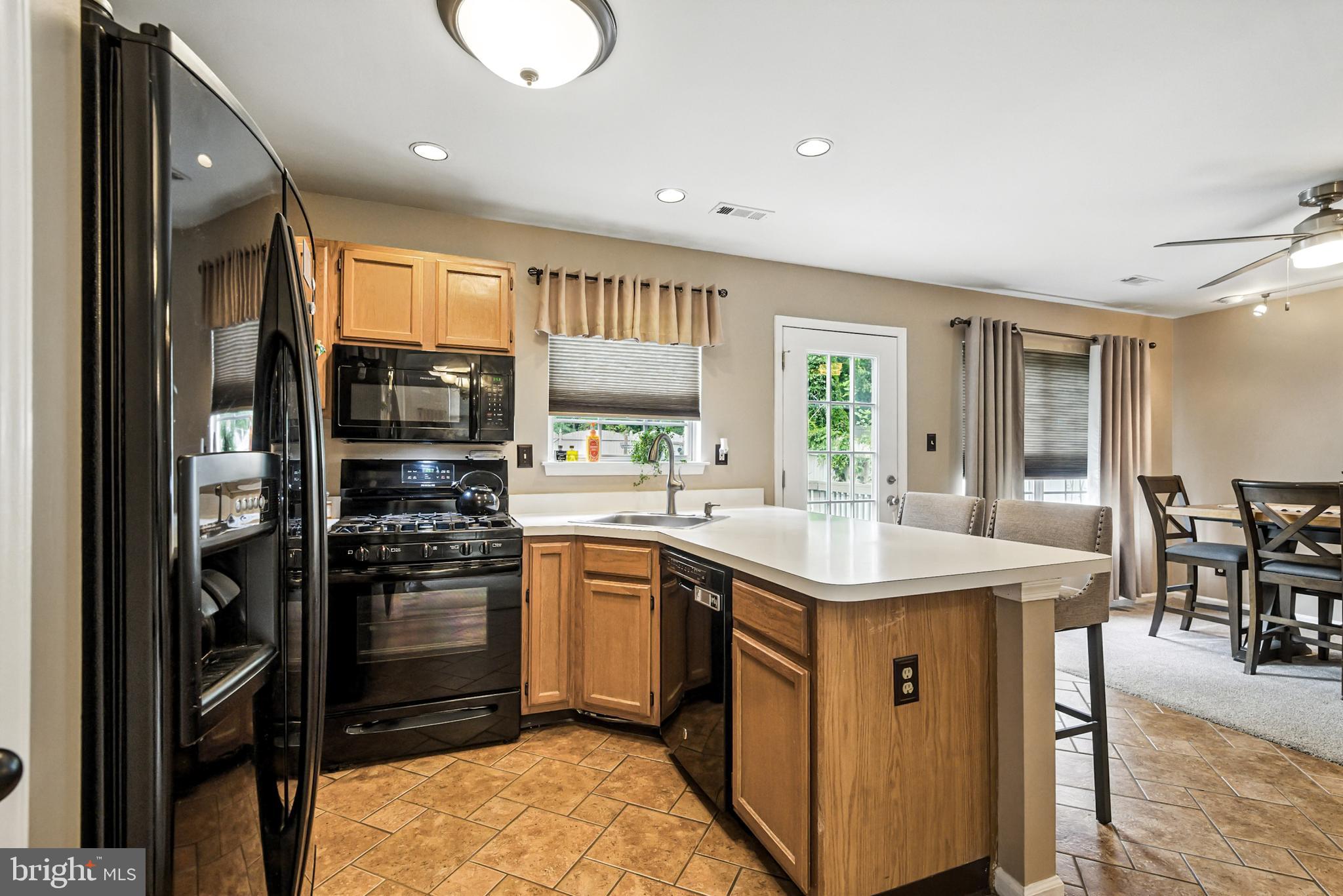 86 Pondview Lane Sicklerville, NJ 08081 - Photo 12 of 35 a kitchen with stainless steel appliances granite countertop a sink stove and refrigerator
