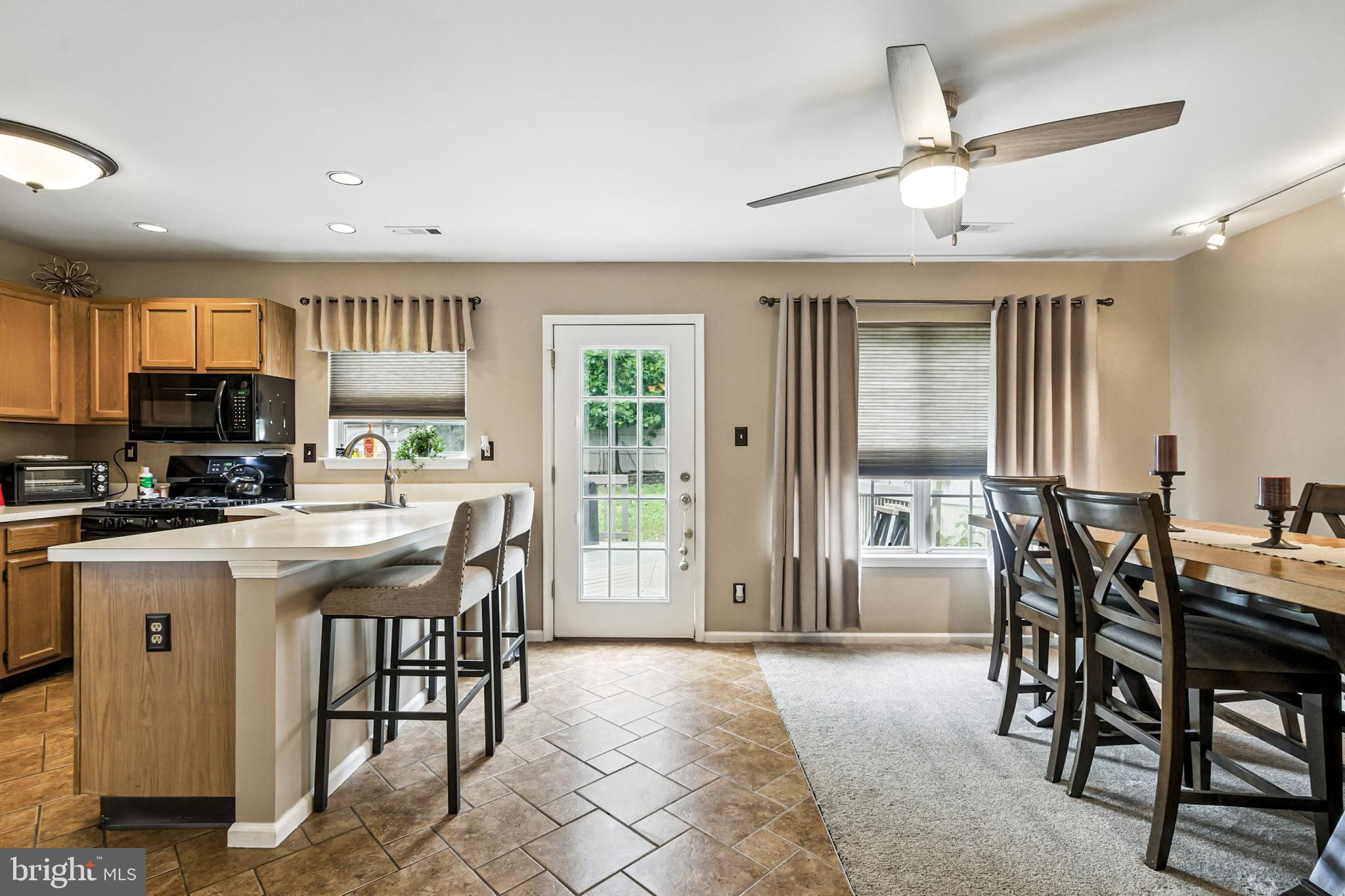 86 Pondview Lane Sicklerville, NJ 08081 - Photo 18 of 35 a kitchen with stainless steel appliances kitchen island granite countertop a table chairs sink and cabinets