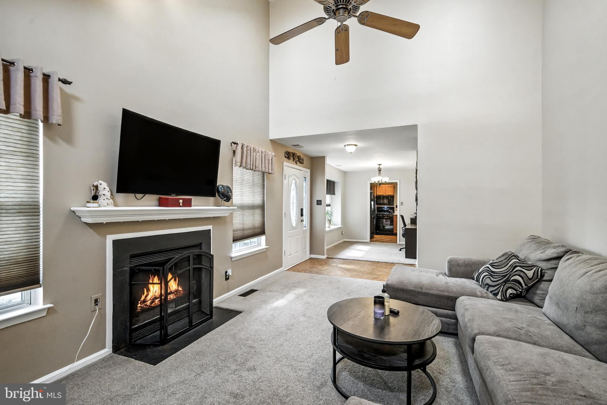 86 Pondview Lane Sicklerville, NJ 08081 - Photo 9 of 35 a living room with furniture a fireplace and a flat screen tv