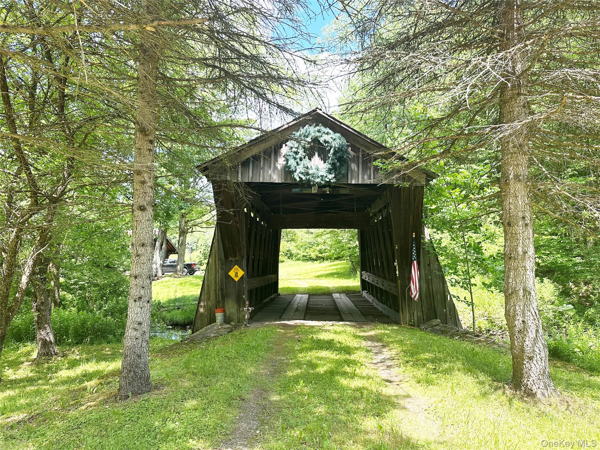 818 Methol Road Roscoe, NY 12776 - Photo 7 of 39 Historic Campbell Covered Bridge entrance included with the property, creating a truly one-of-a-kind arrival experience in the heart of the Catskills.