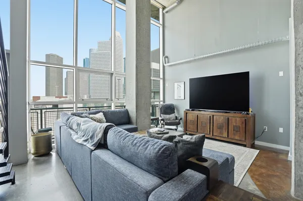 a living room with furniture and a rug