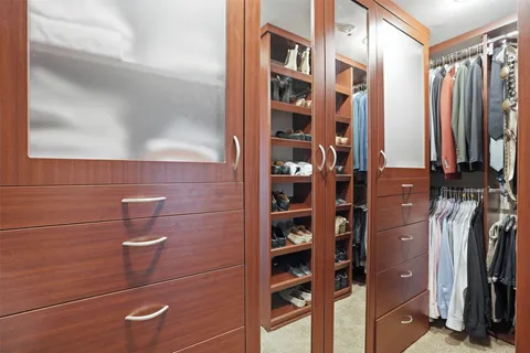 a bathroom with a granite countertop sink mirror vanity and toilet