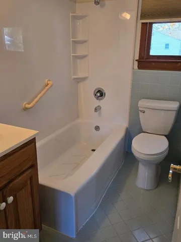 a bathroom with a sink a toilet and bathtub