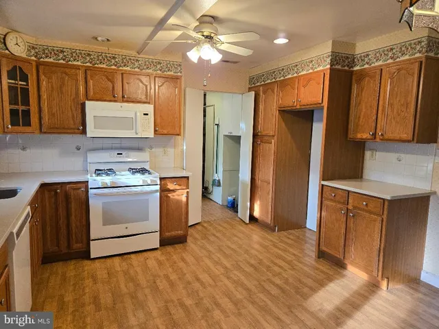 a kitchen with granite countertop a sink cabinets and stainless steel appliances