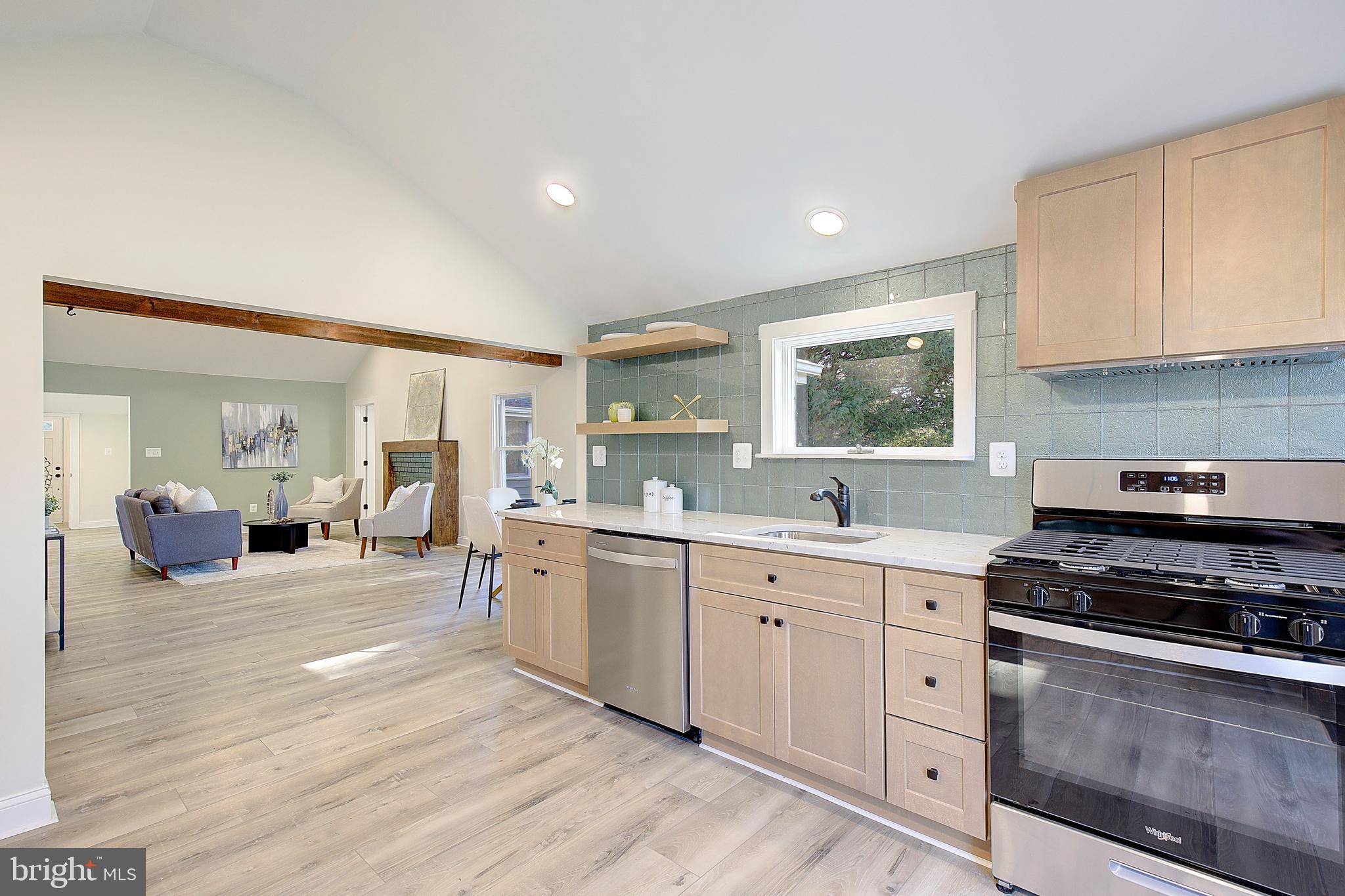 1423 Park Road Edgewater, MD 21037 - Photo 13 of 40 a kitchen with stainless steel appliances a stove a sink cabinets and a wooden floor
