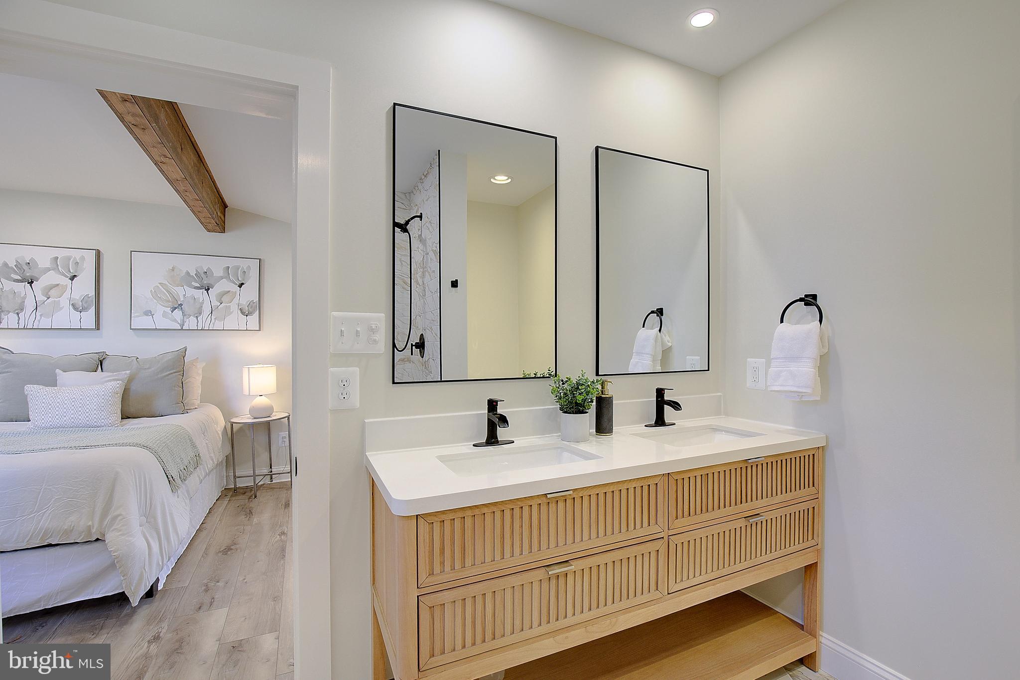 1423 Park Road Edgewater, MD 21037 - Photo 29 of 40 a bathroom with a double vanity sink and a mirror
