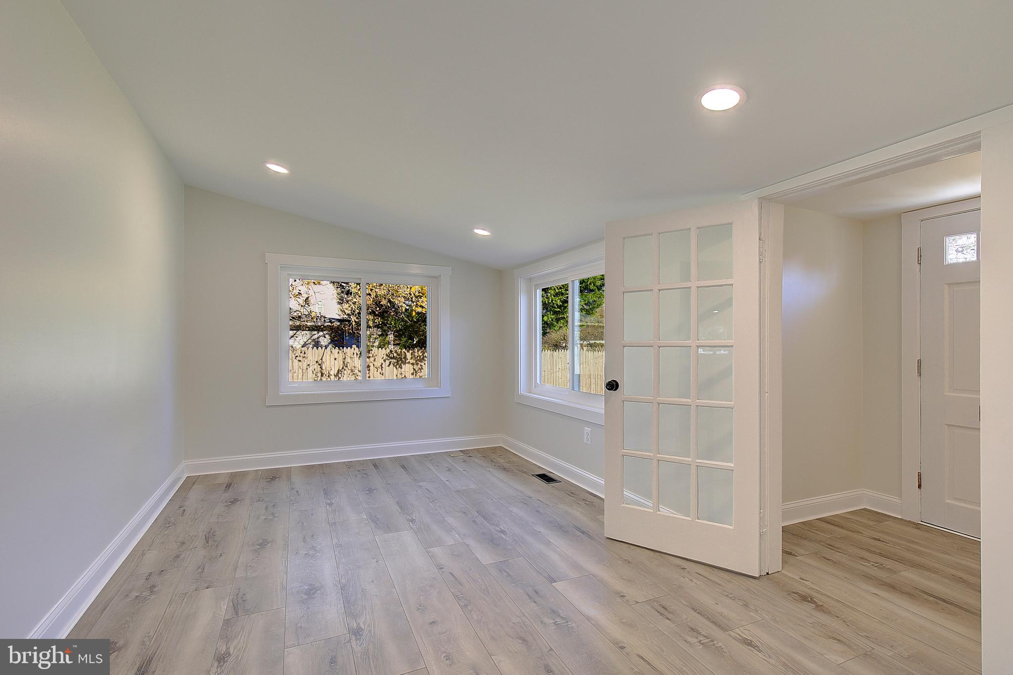 1423 Park Road Edgewater, MD 21037 - Photo 3 of 40 an empty room with wooden floor and windows