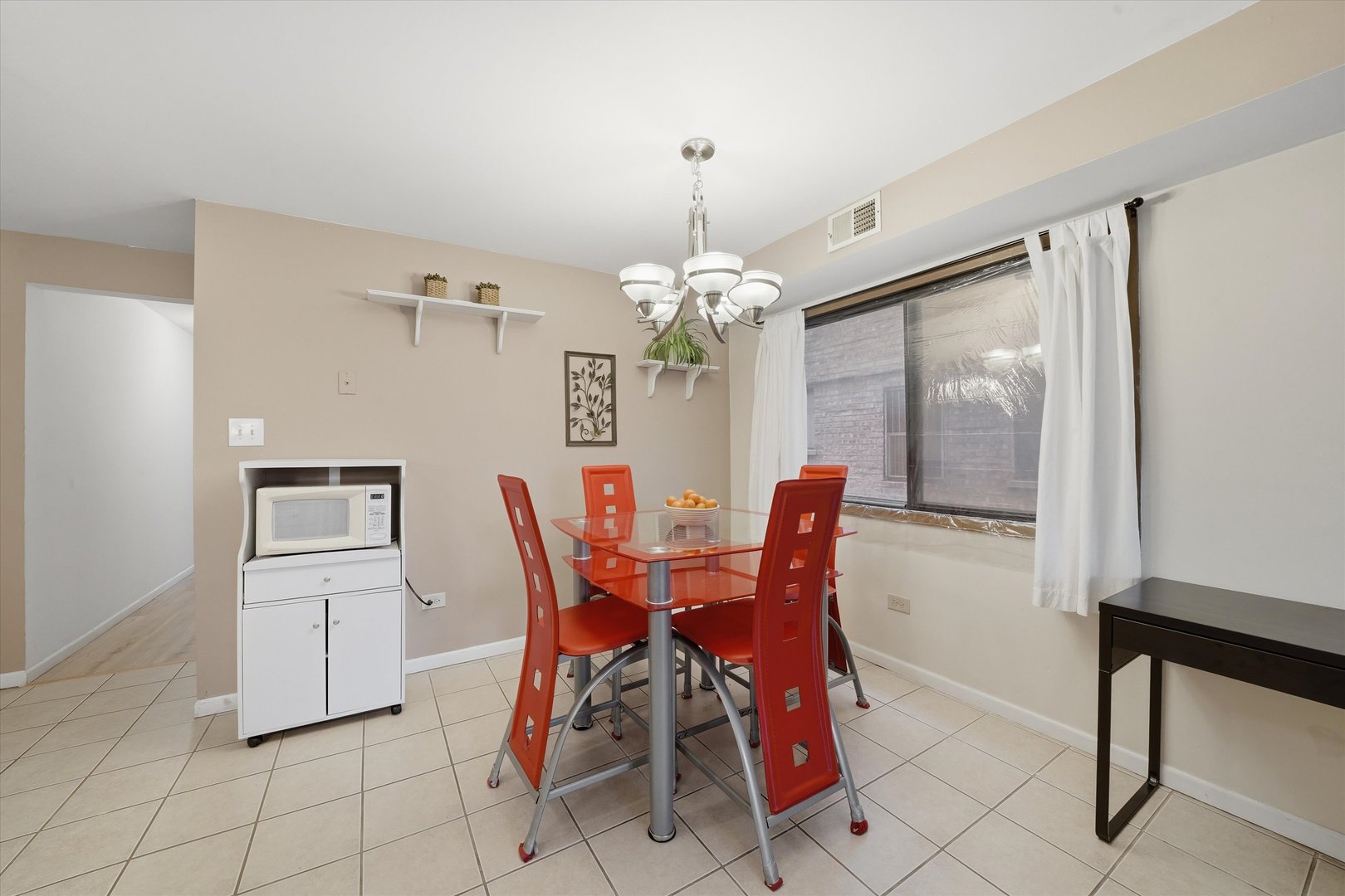 6525 West 64th Place, Unit 1W Chicago, IL 60638 - Photo 4 of 14 a view of a dining room with furniture and chandelier