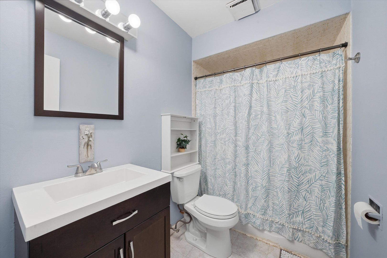 6525 West 64th Place, Unit 1W Chicago, IL 60638 - Photo 8 of 14 a bathroom with a sink a toilet and mirror