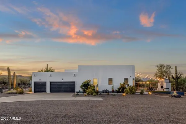 a view of a house with a cars park
