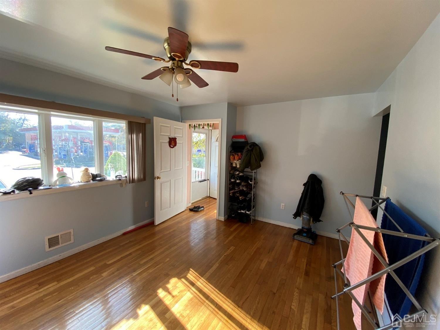 1602 Oak Tree Road Iselin, NJ 08830 - Photo 3 of 13 a view of a room with gym equipment and a window