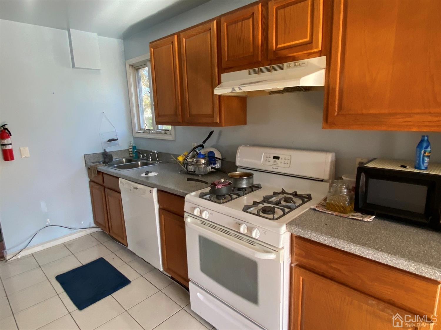 1602 Oak Tree Road Iselin, NJ 08830 - Photo 4 of 13 a kitchen with stainless steel appliances granite countertop a stove a sink and a microwave