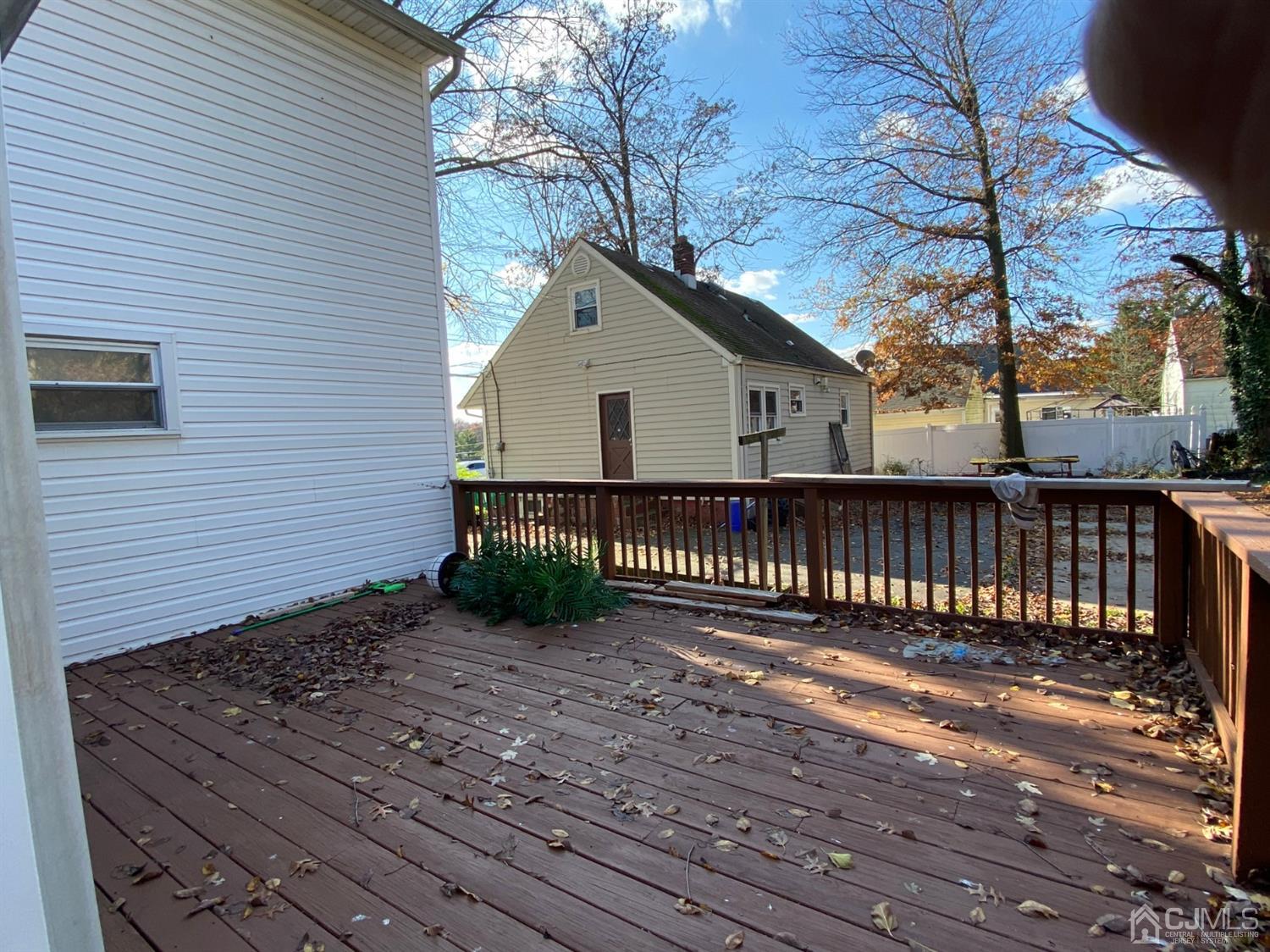 1602 Oak Tree Road Iselin, NJ 08830 - Photo 6 of 13 a view of a house with wooden fence next to a yard