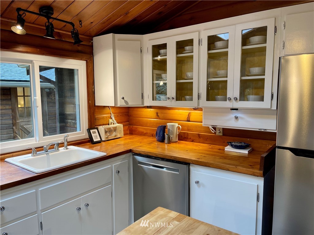 14255 183rd Avenue Southeast Renton, WA 98059 - Photo 13 of 32 a blue kitchen with a sink and refrigerator