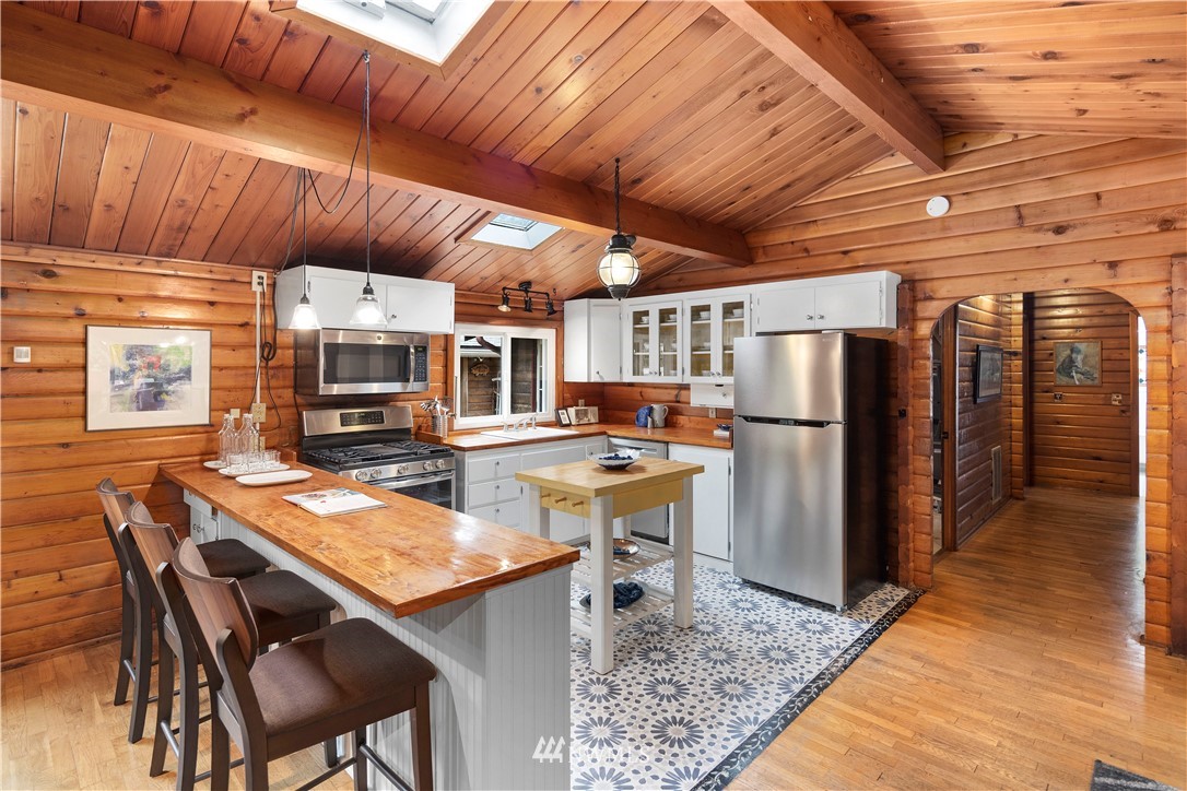 14255 183rd Avenue Southeast Renton, WA 98059 - Photo 14 of 32 a kitchen with stainless steel appliances kitchen island granite countertop a table chairs and a refrigerator