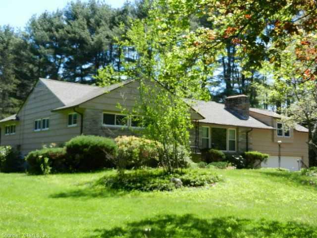 84 Warrenville Road Mansfield, CT 06250 - Photo 1 of 1 a front view of a house with a garden