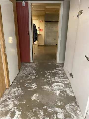 a view of a hallway with wooden walls and a window