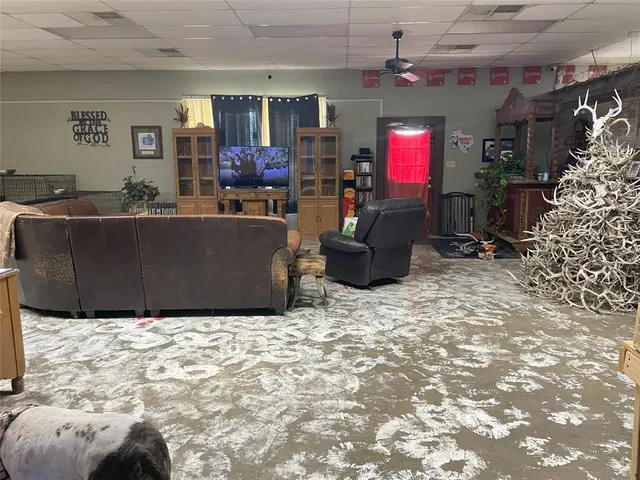 a living room with furniture window and a flat screen tv