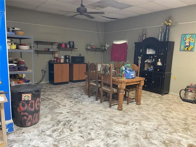 a kitchen with a refrigerator and a table