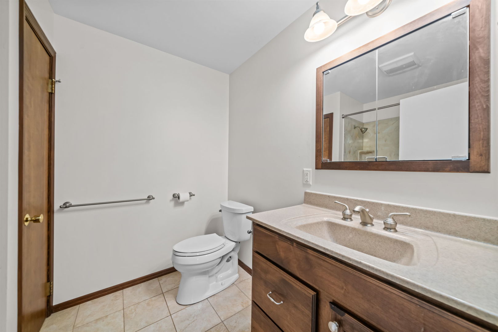 5748 South Skare Road Rochelle, IL 61068 - Photo 20 of 45 a bathroom with a sink a toilet and a mirror