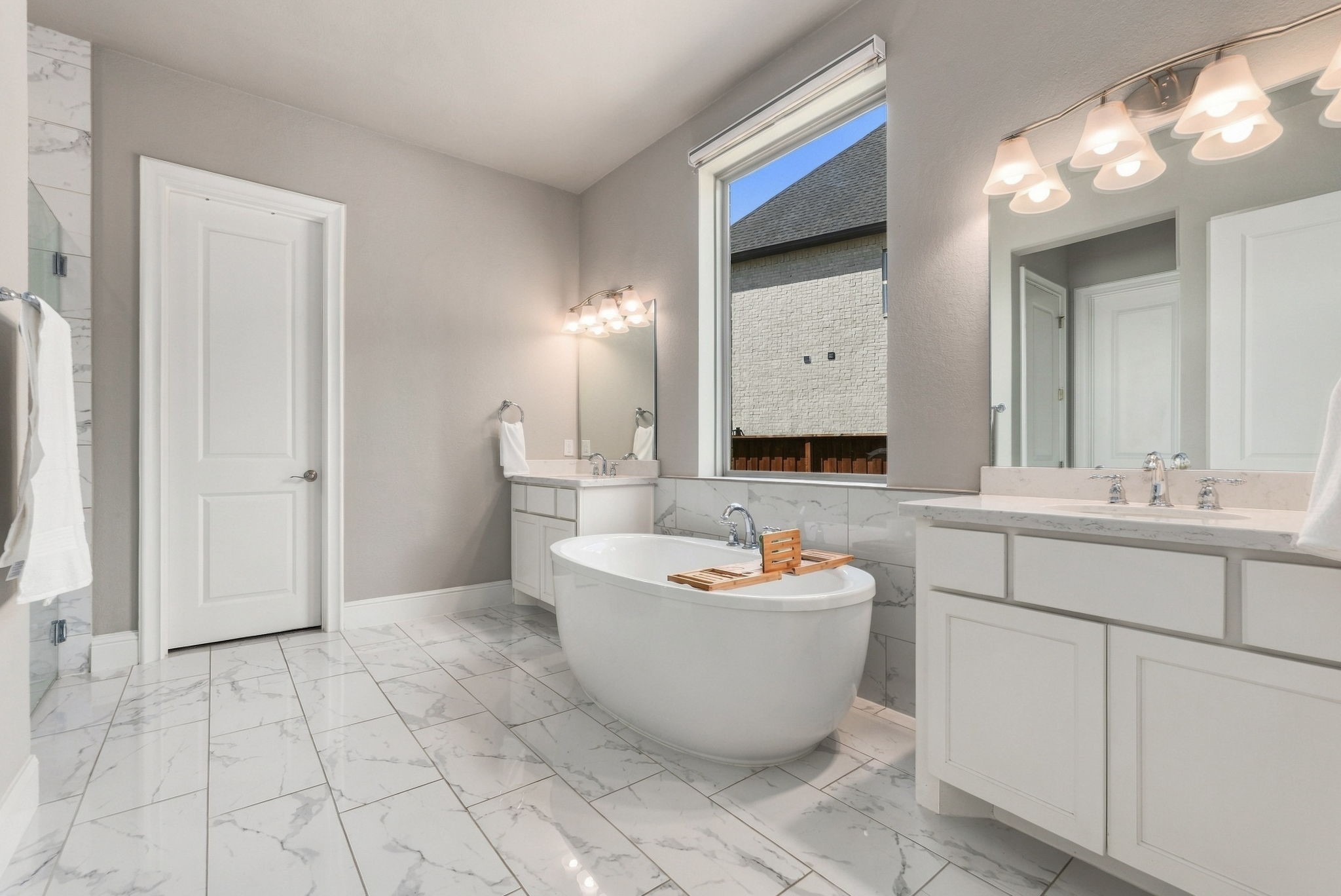 26910 Selinsgrove Road Magnolia, TX 77354 - Photo 24 of 47 A freestanding soaking tub creates a beautiful centerpiece between the dual vanity areas.
