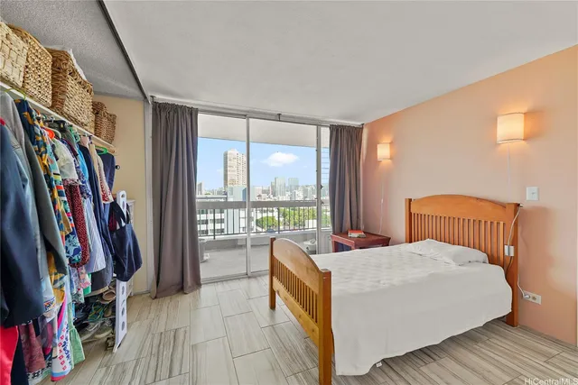 a bedroom with furniture and a large window