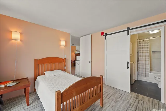 a bedroom with a bed and wooden floor