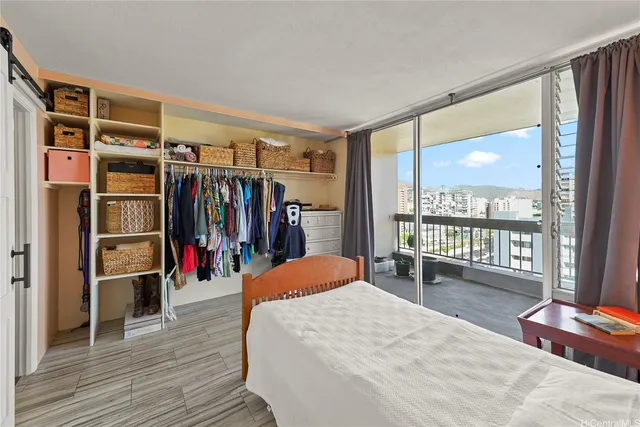 a bed room with a bed and a large window