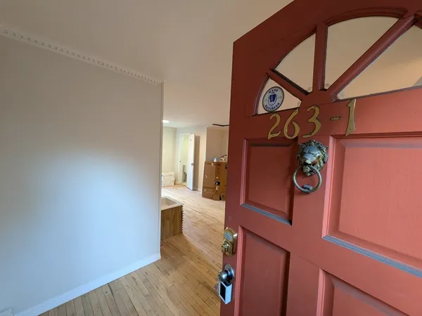 a view of an entryway with wooden floor
