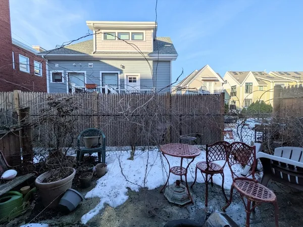 a view of a patio with table and chairs and potted plants