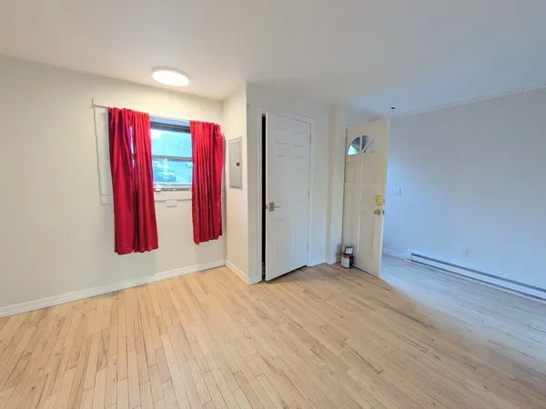 an empty room with closet and wooden floor