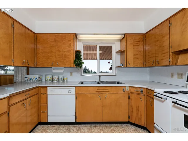 a kitchen with a sink cabinets and window