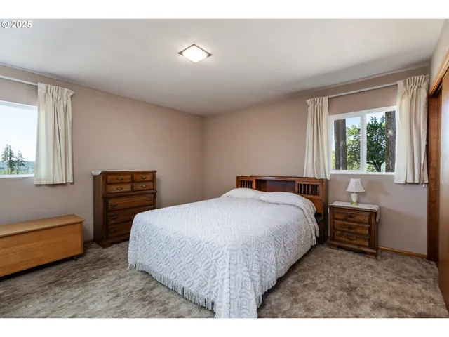 a bedroom with a bed next to a window