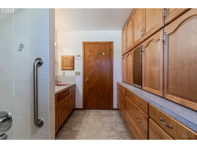 a bathroom with a sink a mirror and a shower