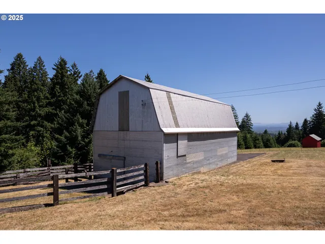 a view of swimming pool with outdoor seating and trees in the background
