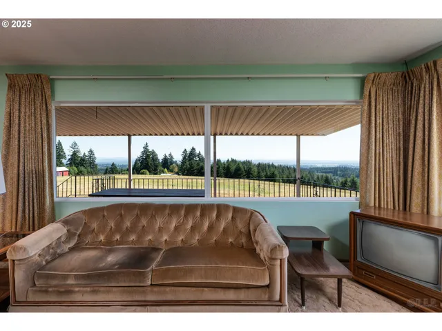 a view of a balcony with furniture and garden