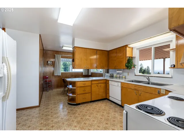 a kitchen with stainless steel appliances kitchen island granite countertop a refrigerator and a sink