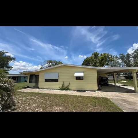 a view of house with yard