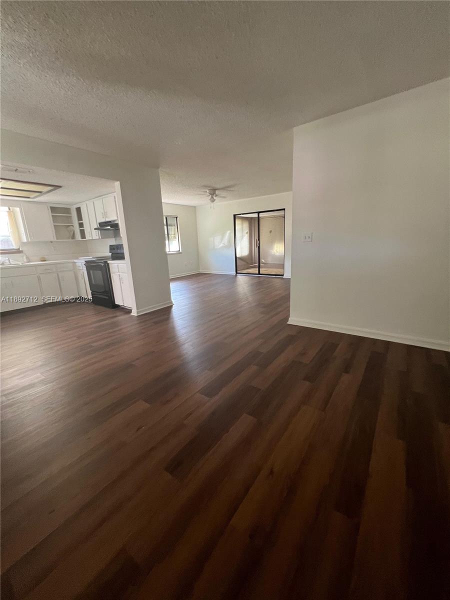 8935 Southwest 104th Place Ocala, FL 34481 - Photo 11 of 21 a view of empty room with wooden floor and fan